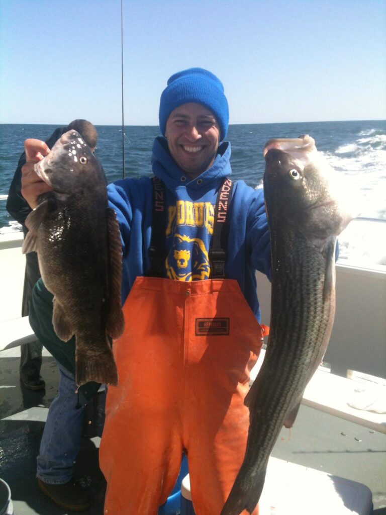 man holding two fishes